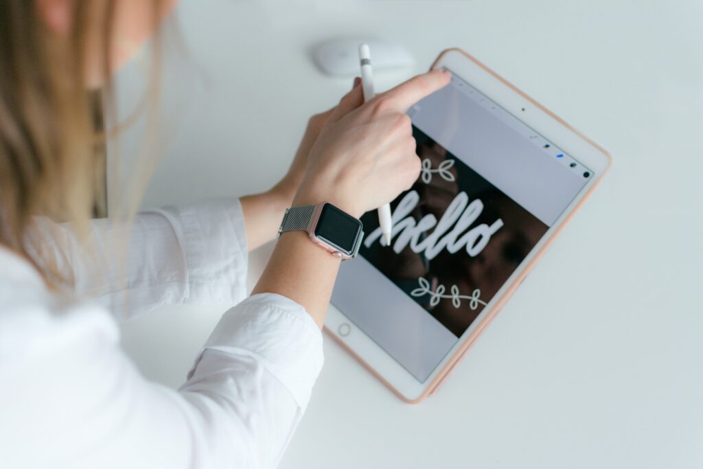 A small business owner is designing her brand logo on her Ipad.